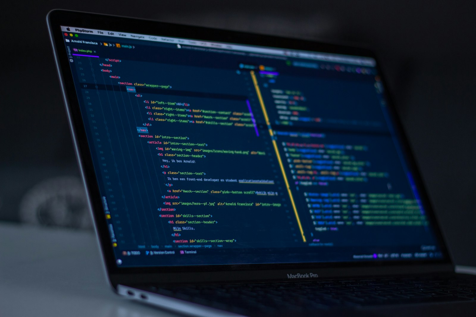 Software developer writing code on a dark IDE screen